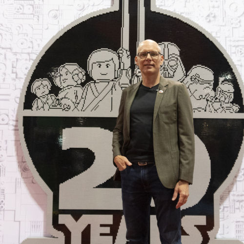 Michael Lee Stockwell in front of brick-built LEGO Star Wars logo